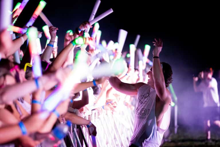 Glow dance event with vibrant neon lights and energetic crowd at Operation Glow festival.