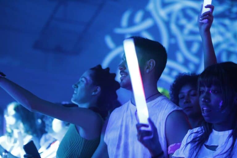 Glow-in-the-dark dance party with vibrant lights and energetic participants at Operation Glow event.